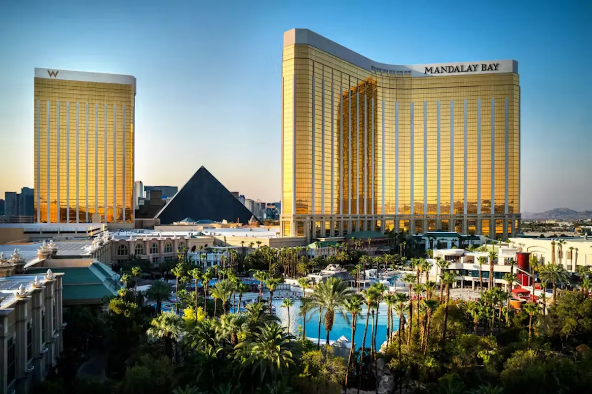 Golden-hour Mandalay Bay and pool complex aerial at Tailgate Beach Club