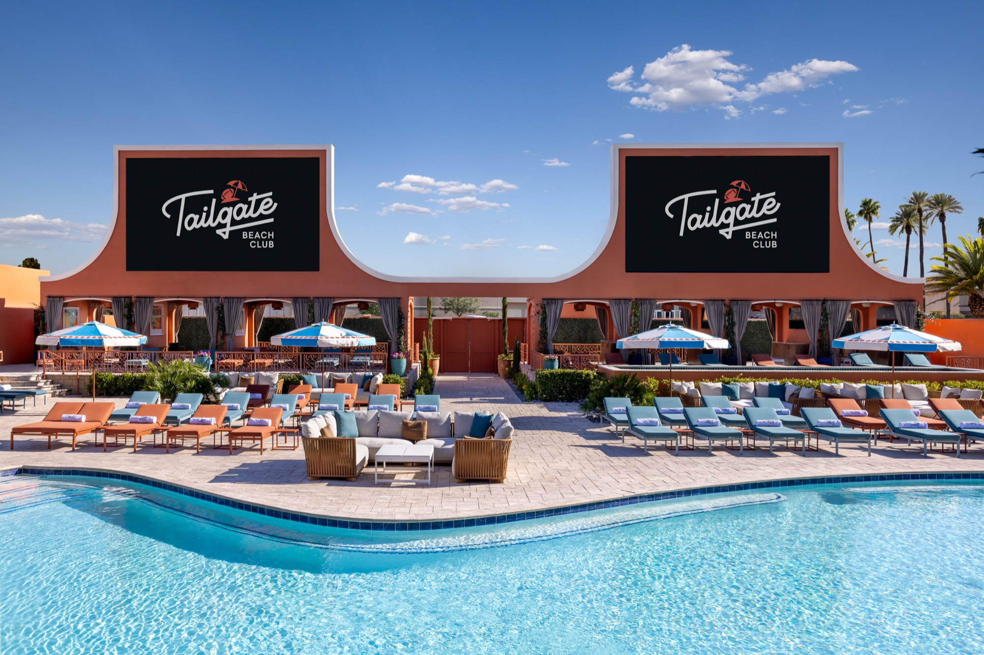 a pool with chairs and a building with a sign