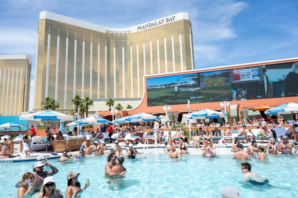 Wide packed pool under Mandalay Bay and screen at Tailgate Beach Club