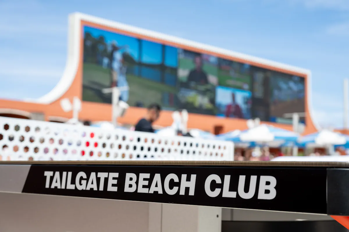 Tailgate Beach Club table sign with screen behind
