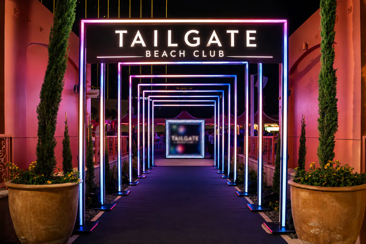 Neon-lit Tailgate Beach Club tunnel entrance at night