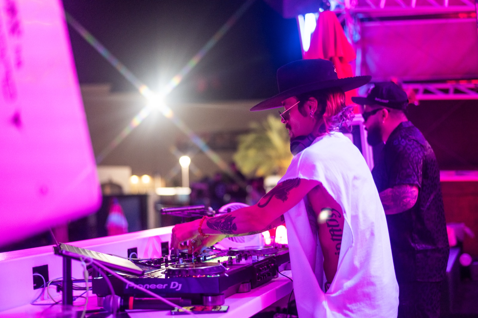DJ duo at the decks in pink light at Neon Vibra