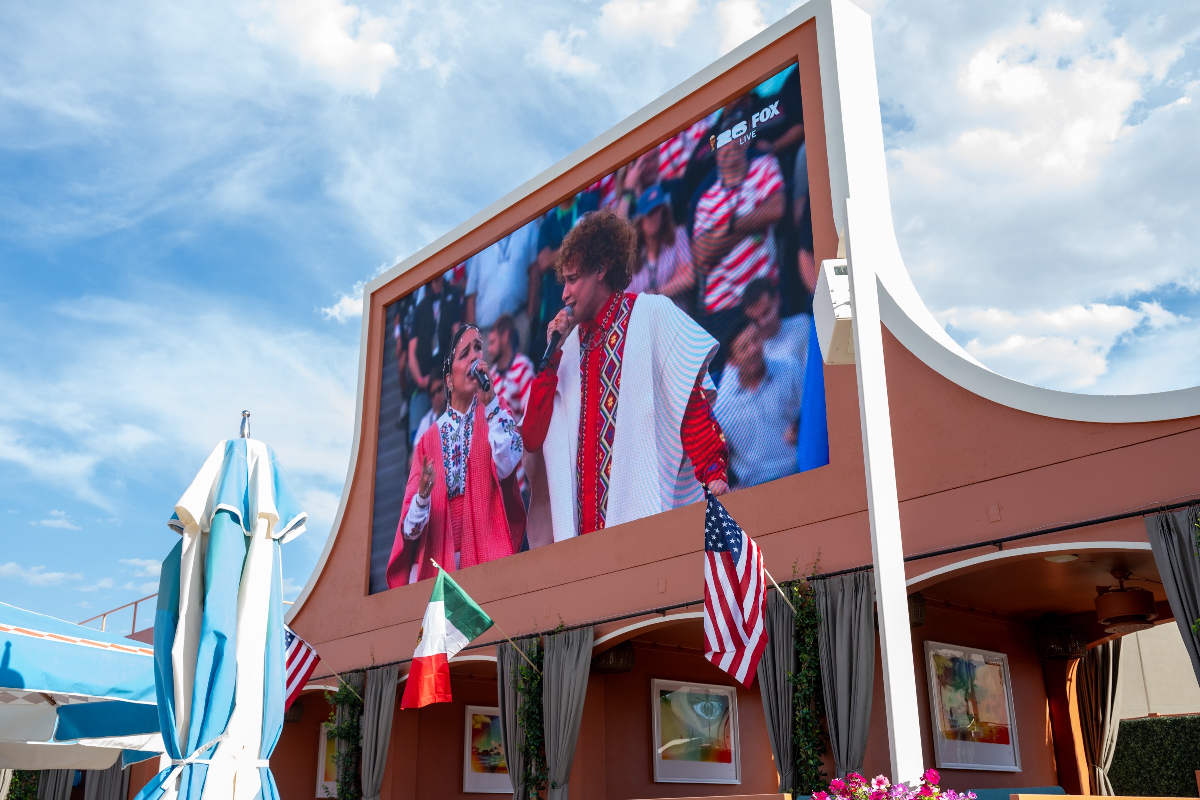 a large screen with a picture of a man singing into a microphone
