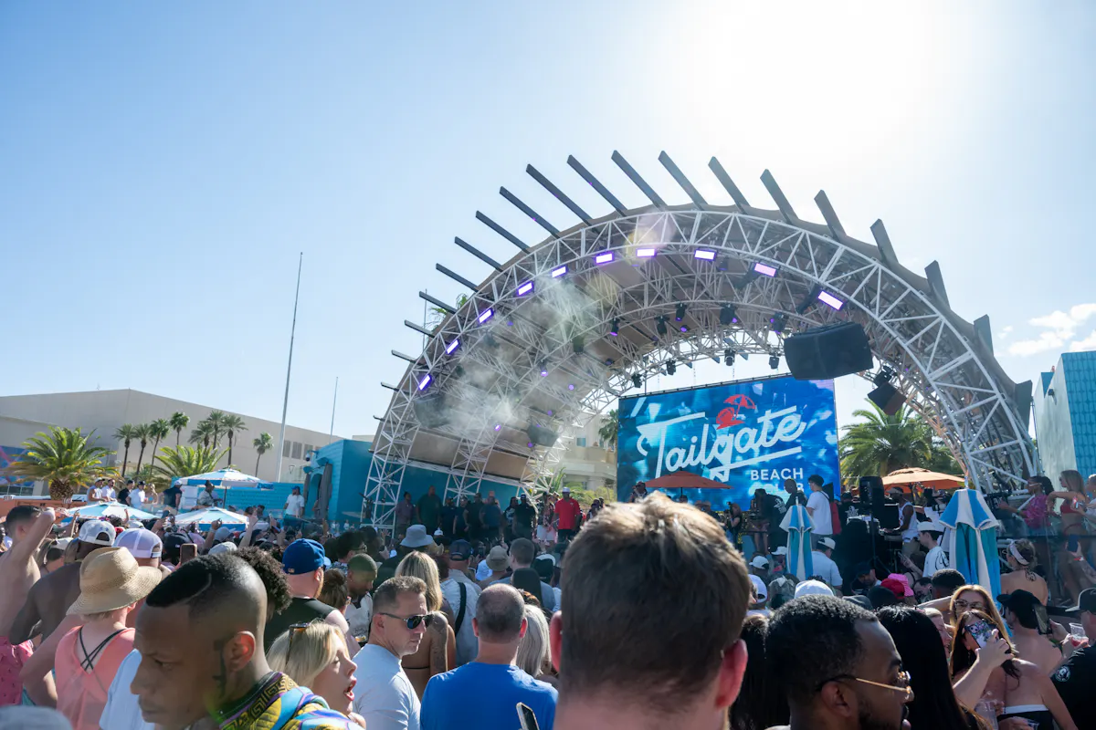 Packed crowd under the stage arch, venue scale at Tailgate Beach Club