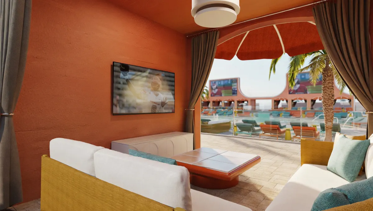 Cabana interior couch and TV overlooking pool at Tailgate Beach Club