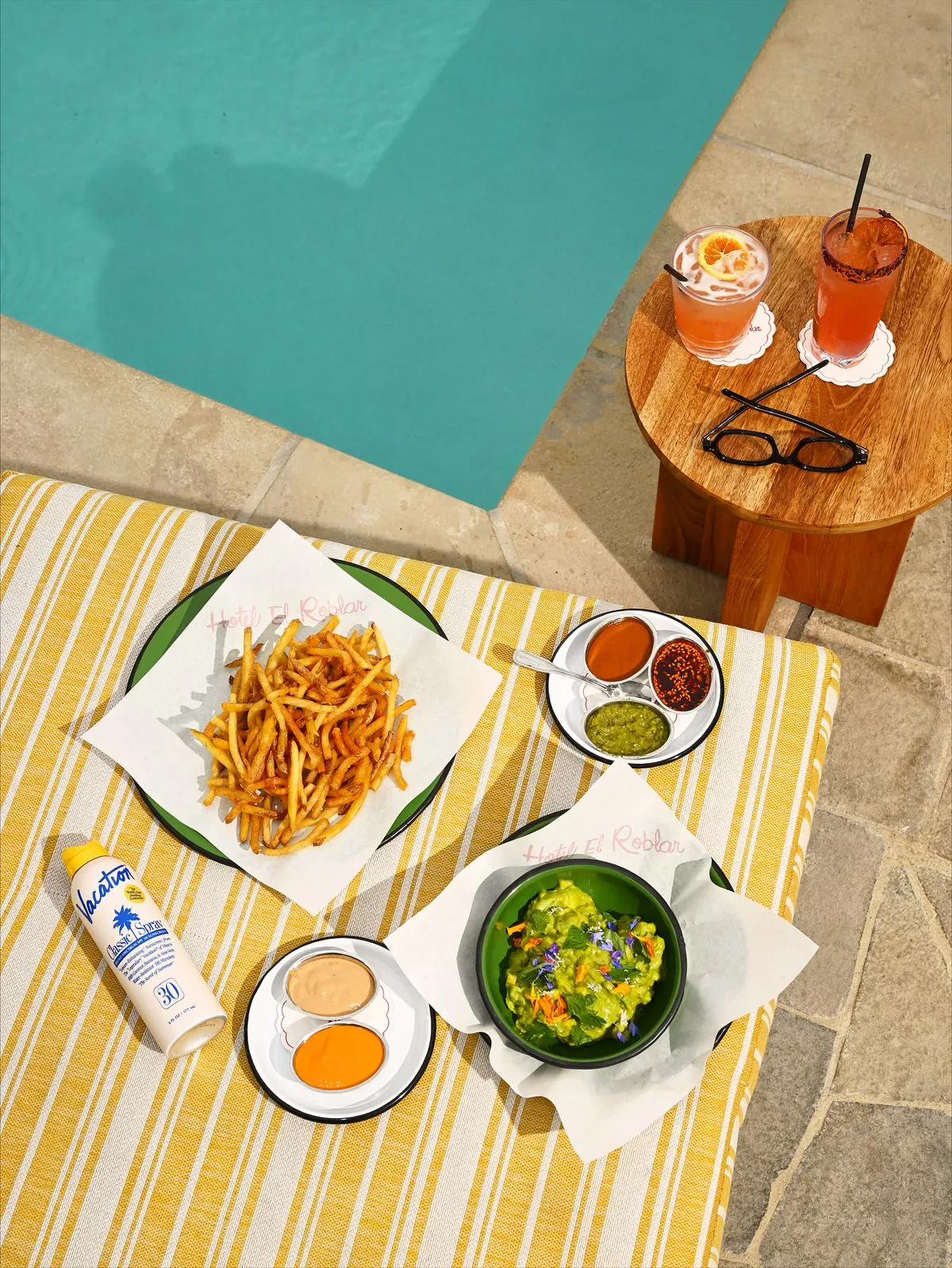 Styled poolside food spread with fries and cocktail at Tailgate Beach Club