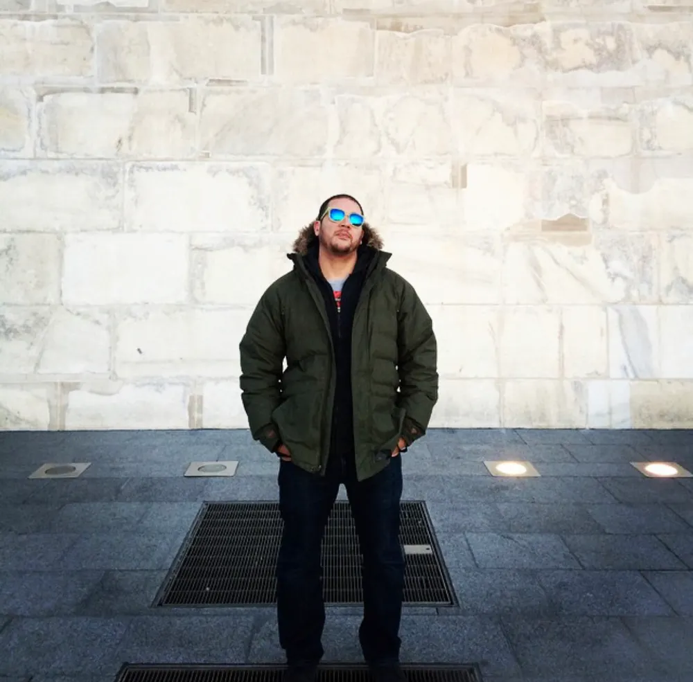 a man standing in front of a building
