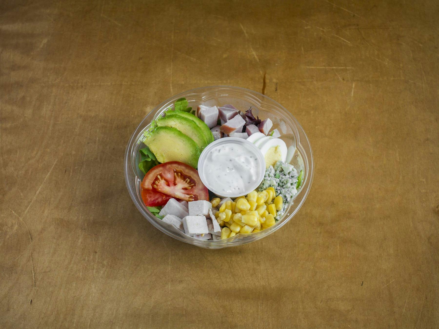 a bowl topped with tomatoes, corn grains and other ingredients