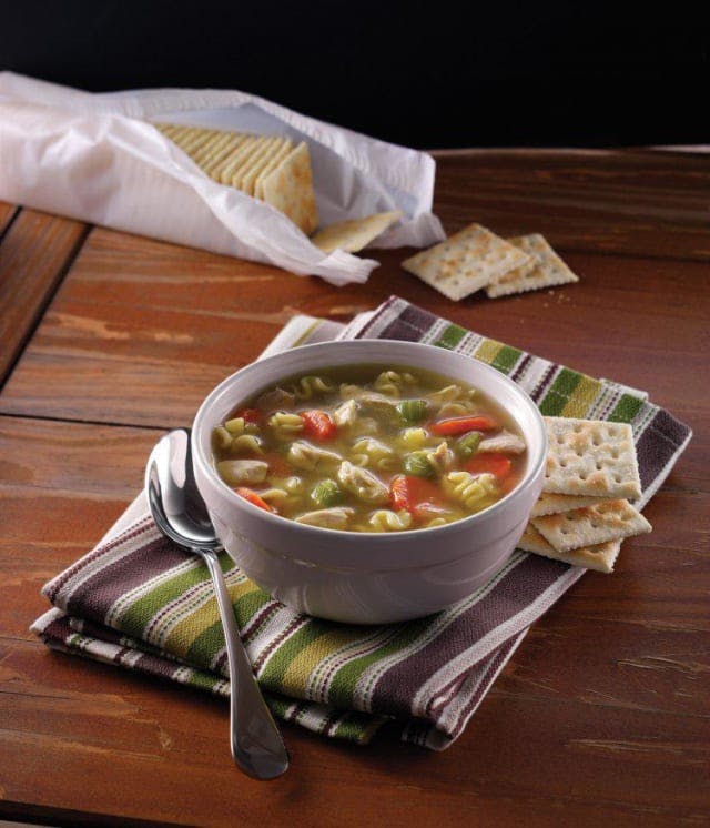 a bowl of food sitting on top of a wooden table