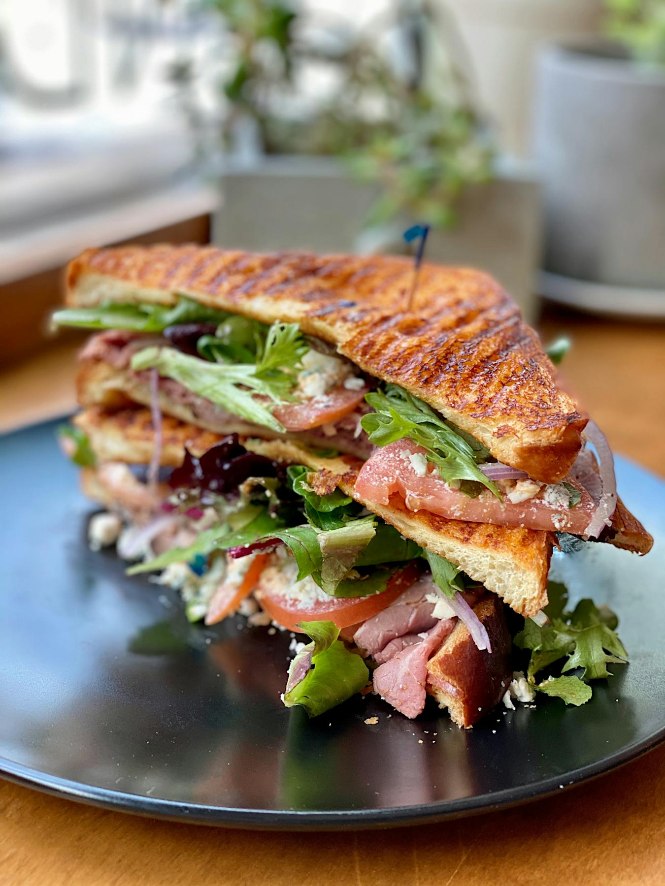 a close up of a sandwich and salad on a plate