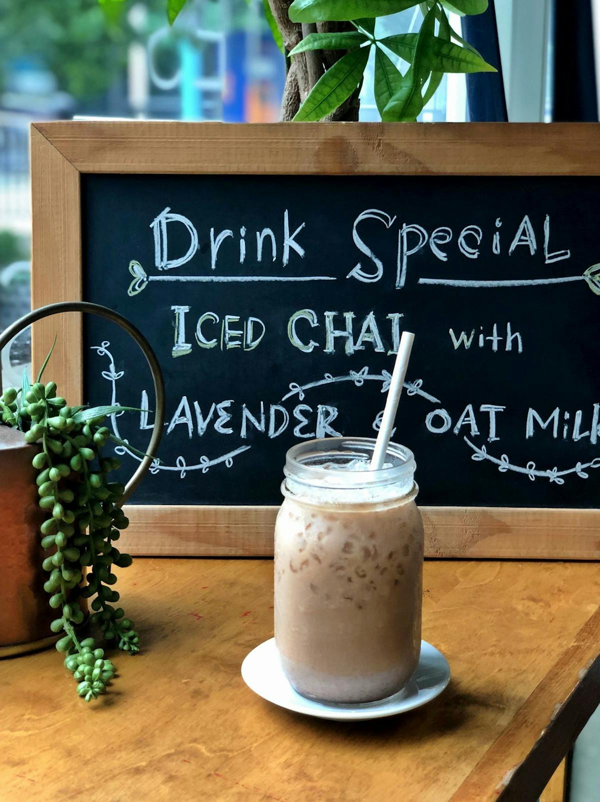a charcoal blackboard with a drink in front