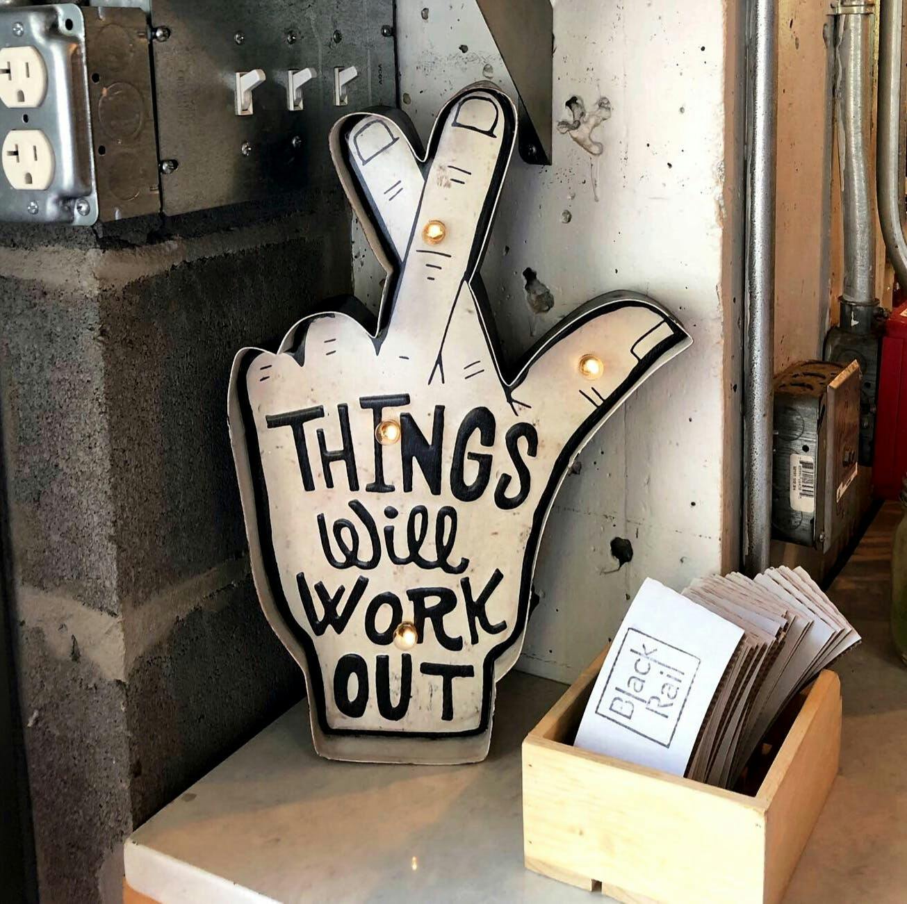 a sign of a hand crossing fingers with black text