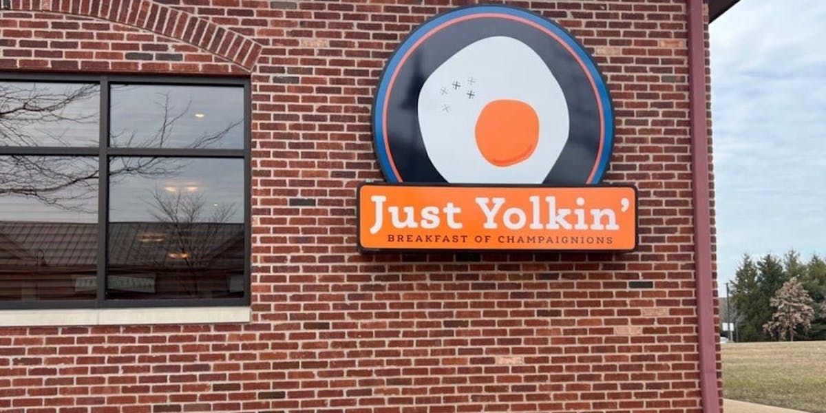 a sign on the side of a brick building