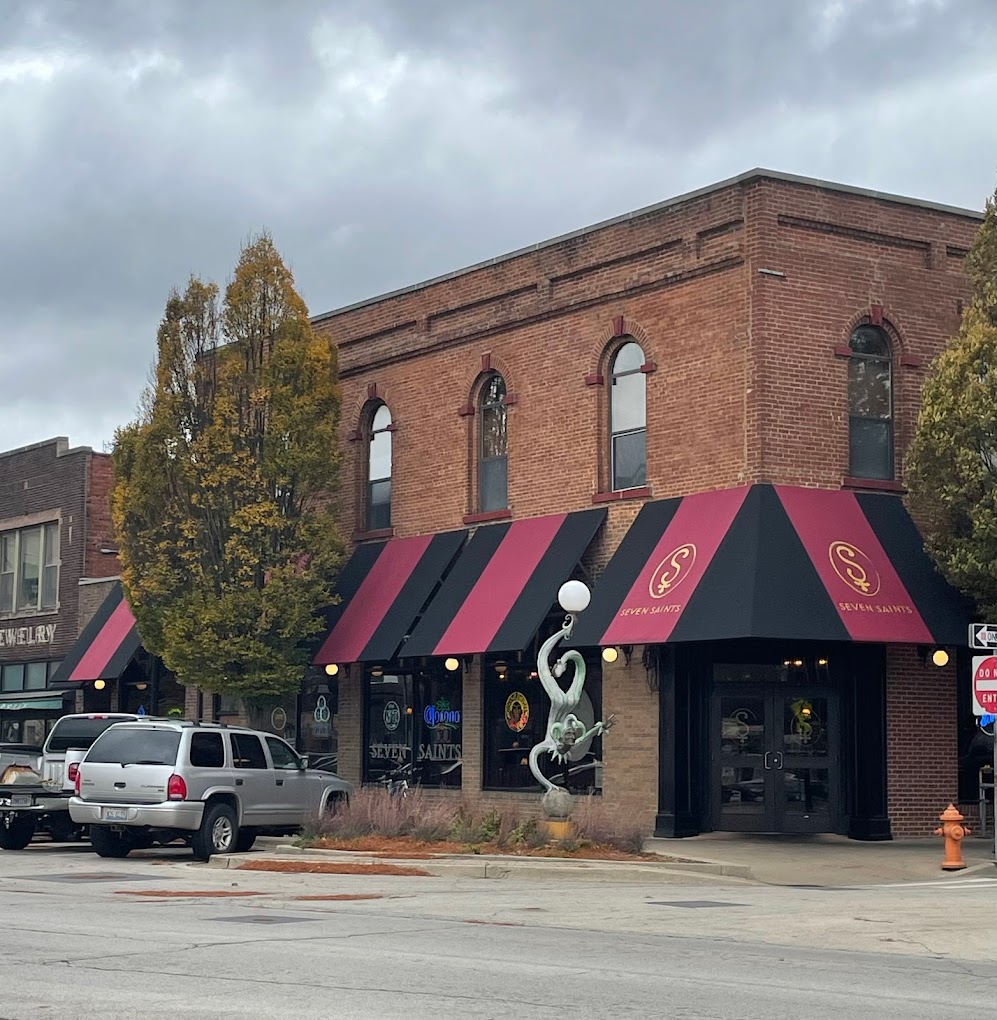 a small clock tower in front of a house