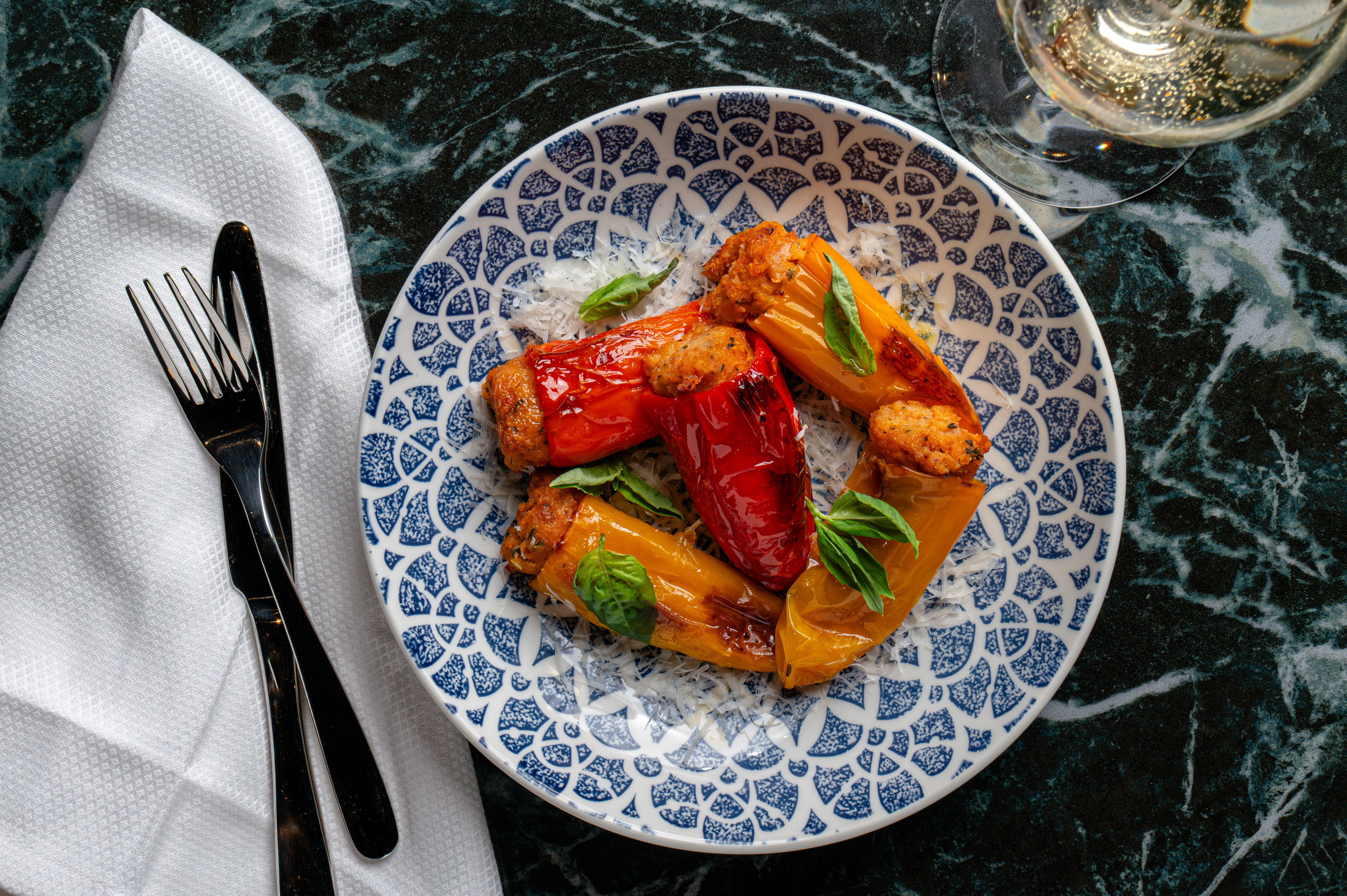 Stuffed red and yellow peppers garnished with basil and Parmesan at Leola Baha Mar.