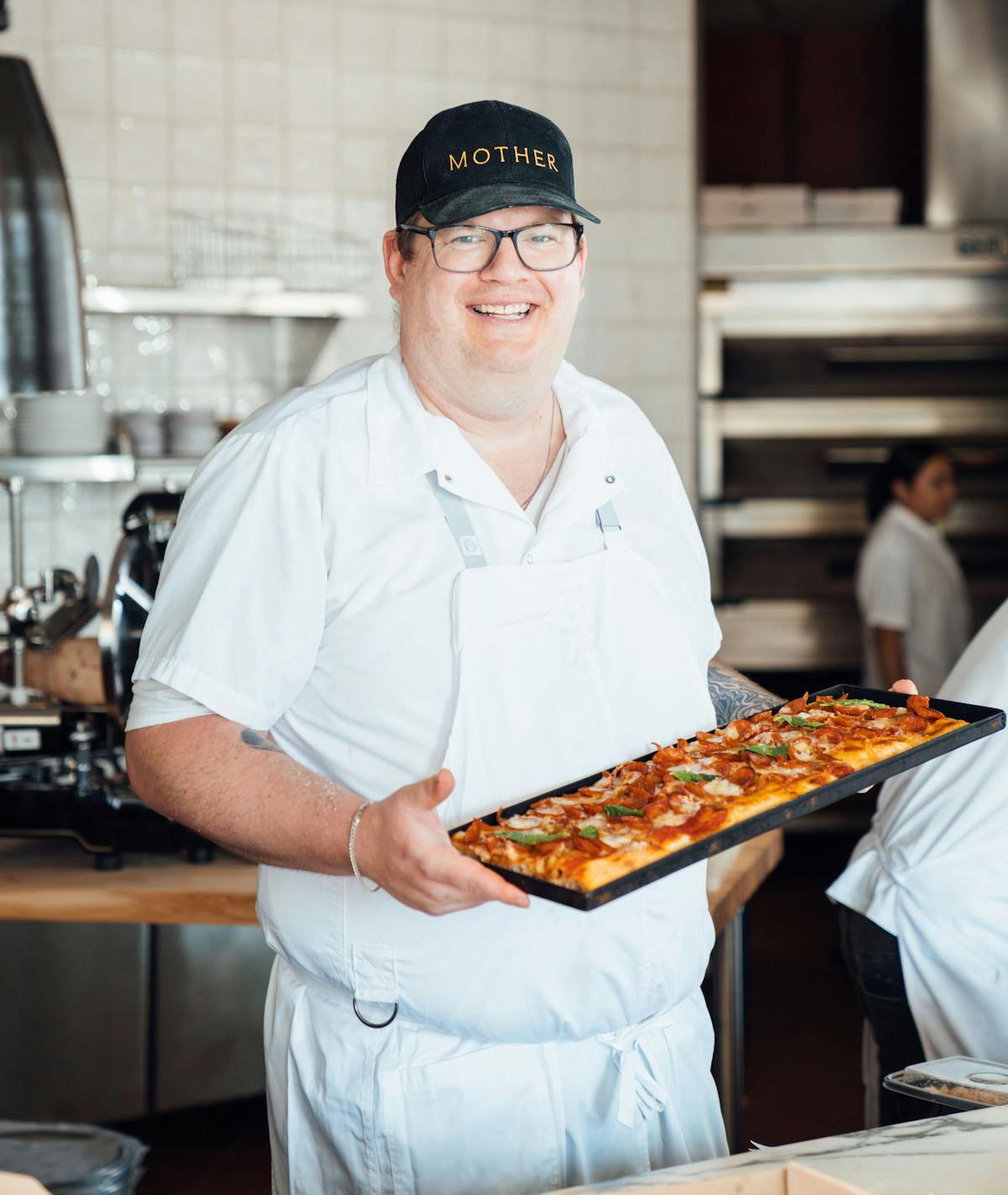 a person holding a pizza tray