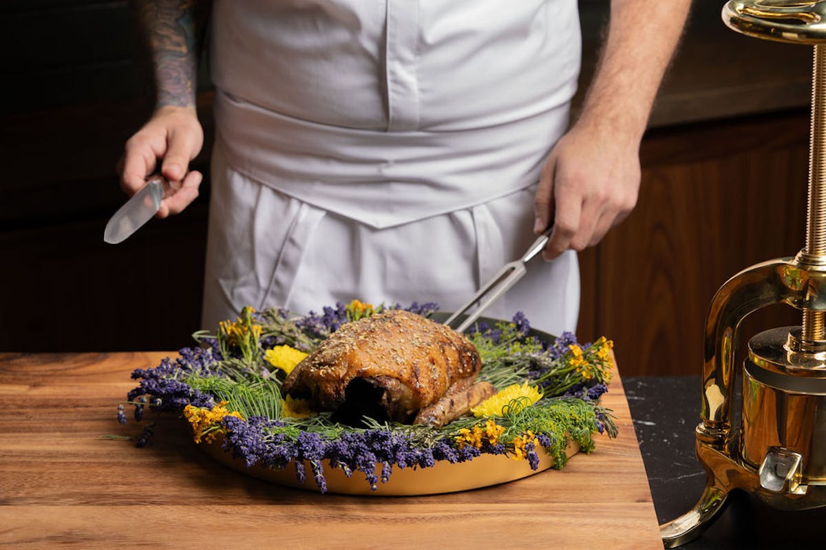 a man cutting a cake with a knife