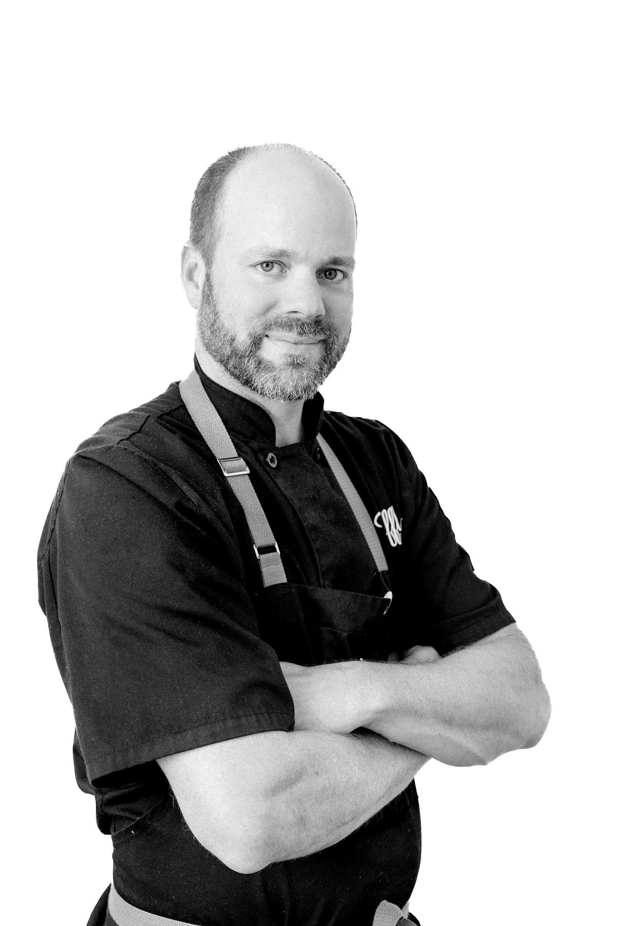 Black and white portrait of Tret Jorden, Truffles Fine Foods Culinary Director