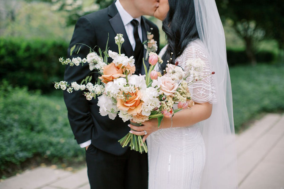 a person in a suit holding a flower