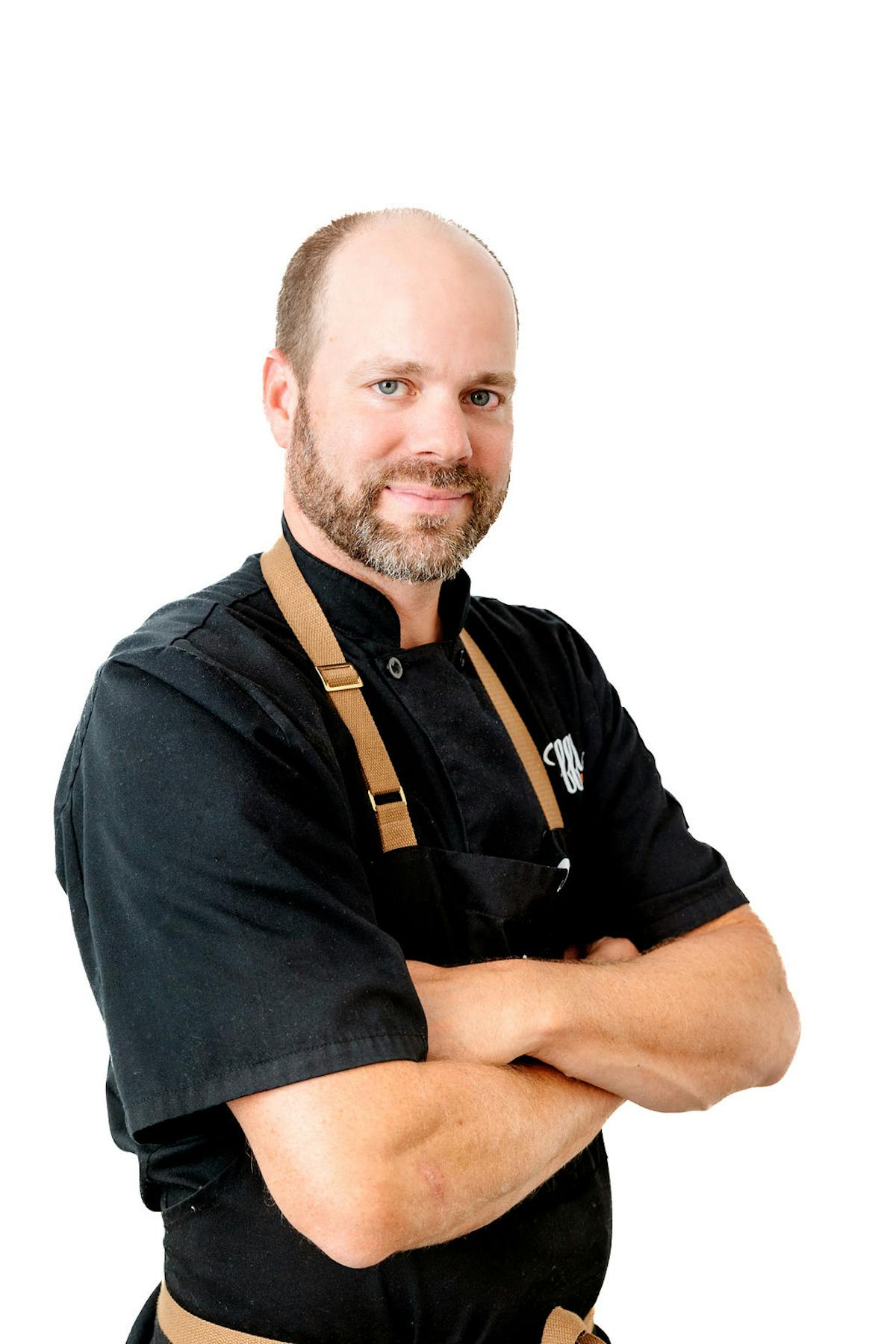 Truffles Fine Foods culinary director Tret Jordan headshot in chef uniform