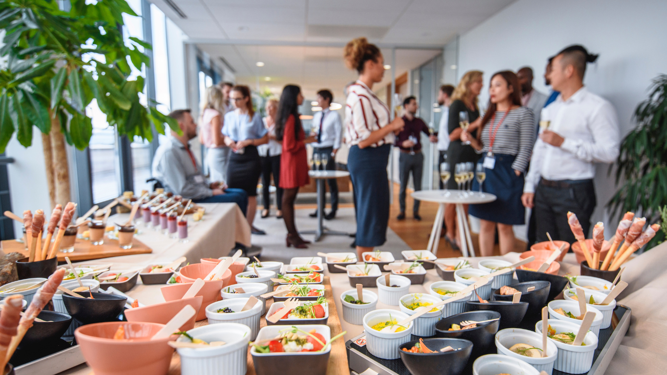a group of people sitting at a table full of food