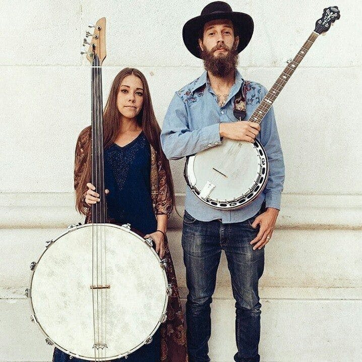 a man and a woman standing in front of a instrument