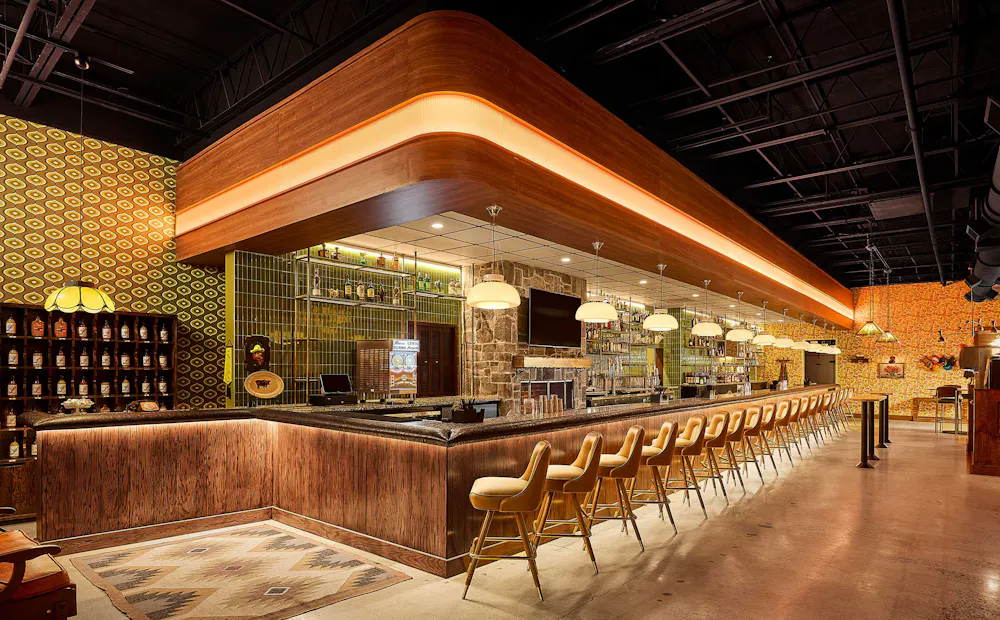 a bar with chairs and lights