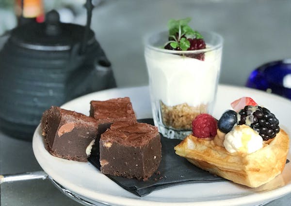 a plate of food with a slice of cake on a table