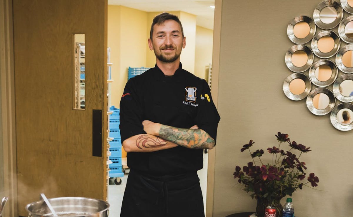 chef standing in front of food