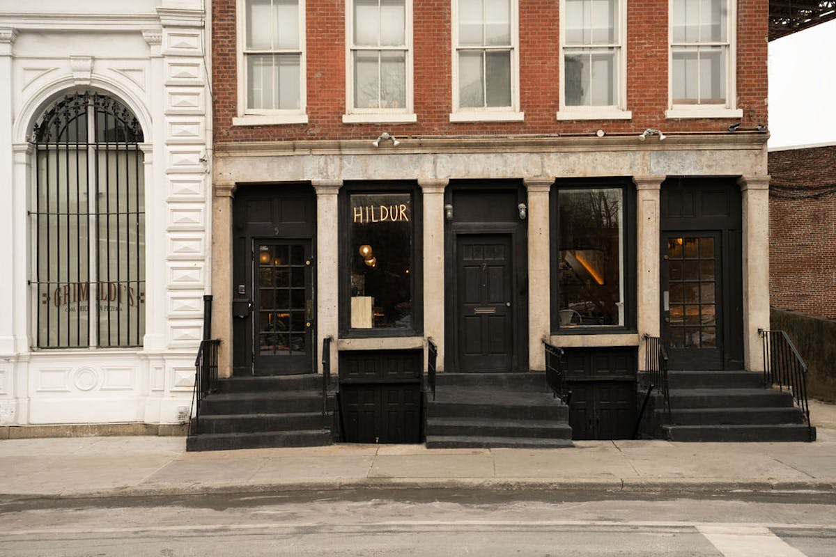 a person sitting on a bench in front of a building