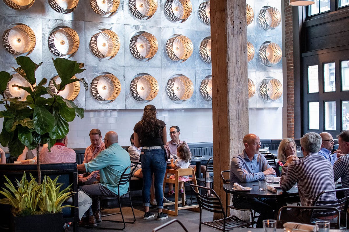 a group of people sitting at a table in a restaurant