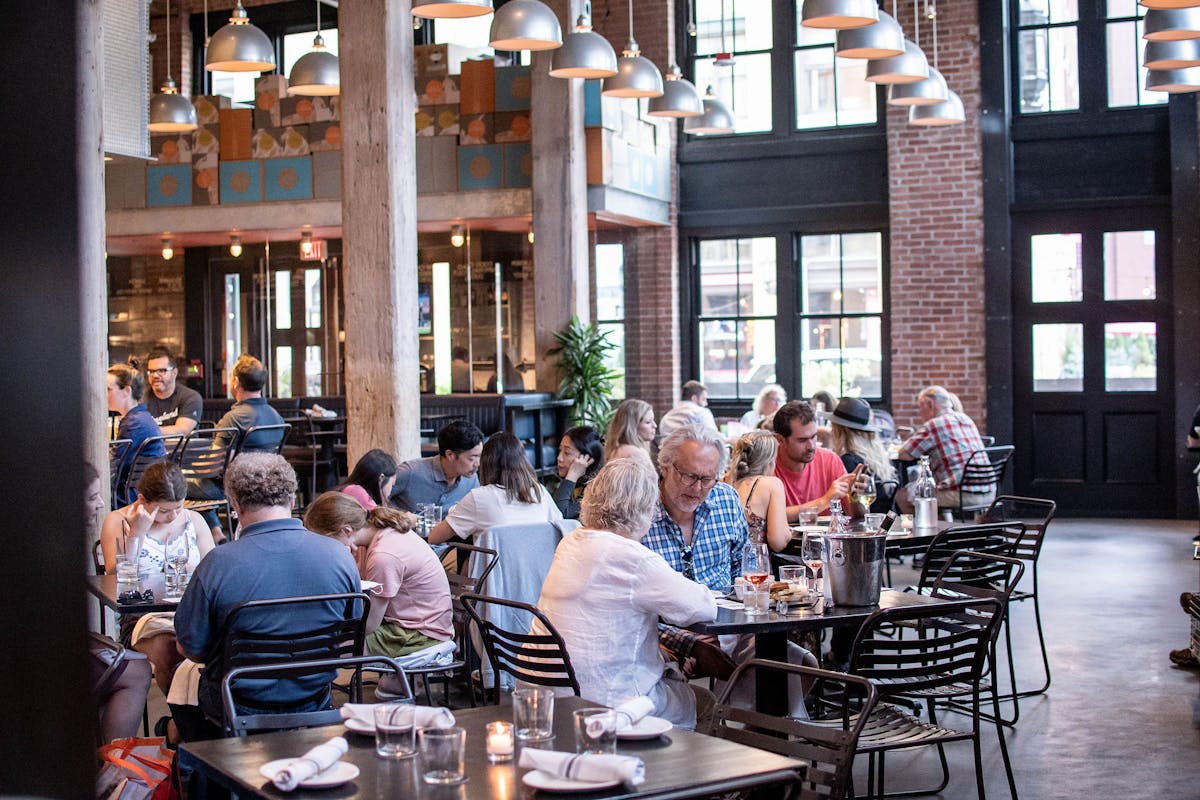 a group of people sitting at a table in a restaurant