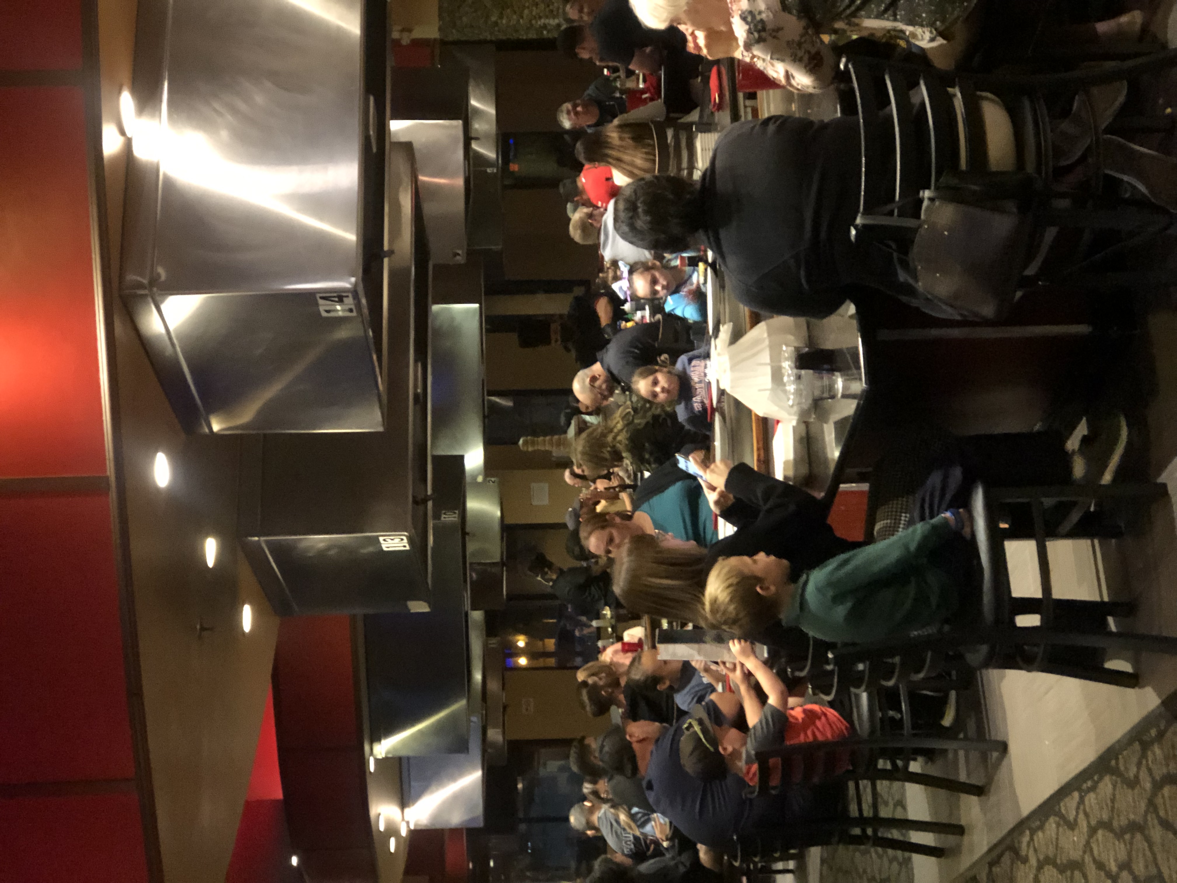a group of people sitting at a table in a restaurant
