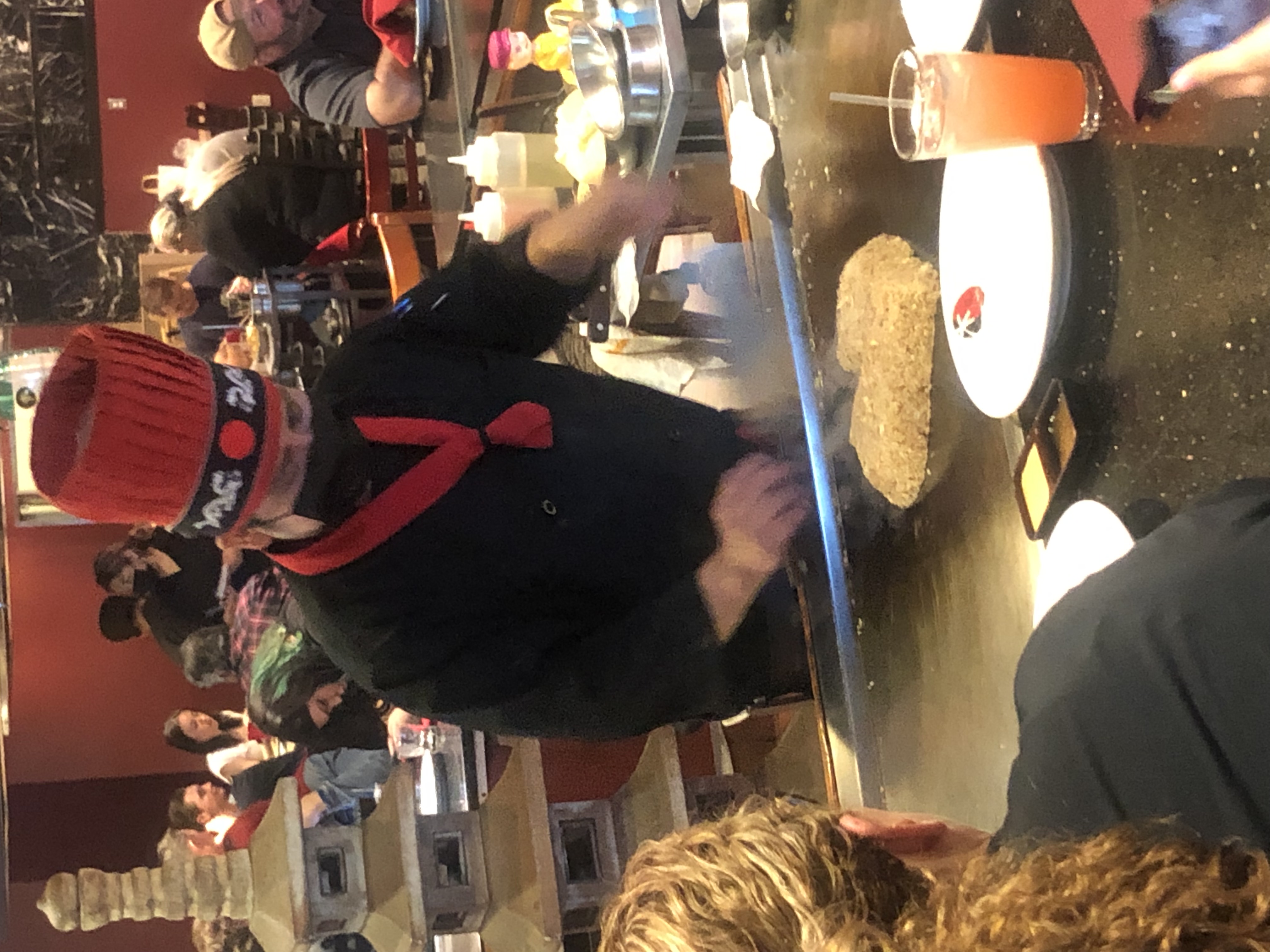 a group of people sitting at a table with food