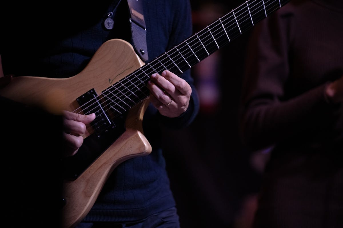person playing a wooden guitar