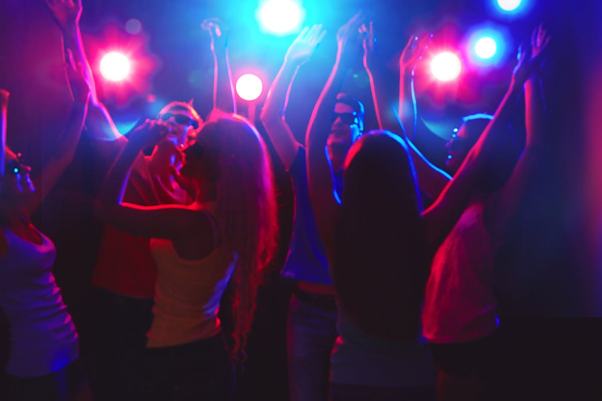 people dancing at a bar with live music