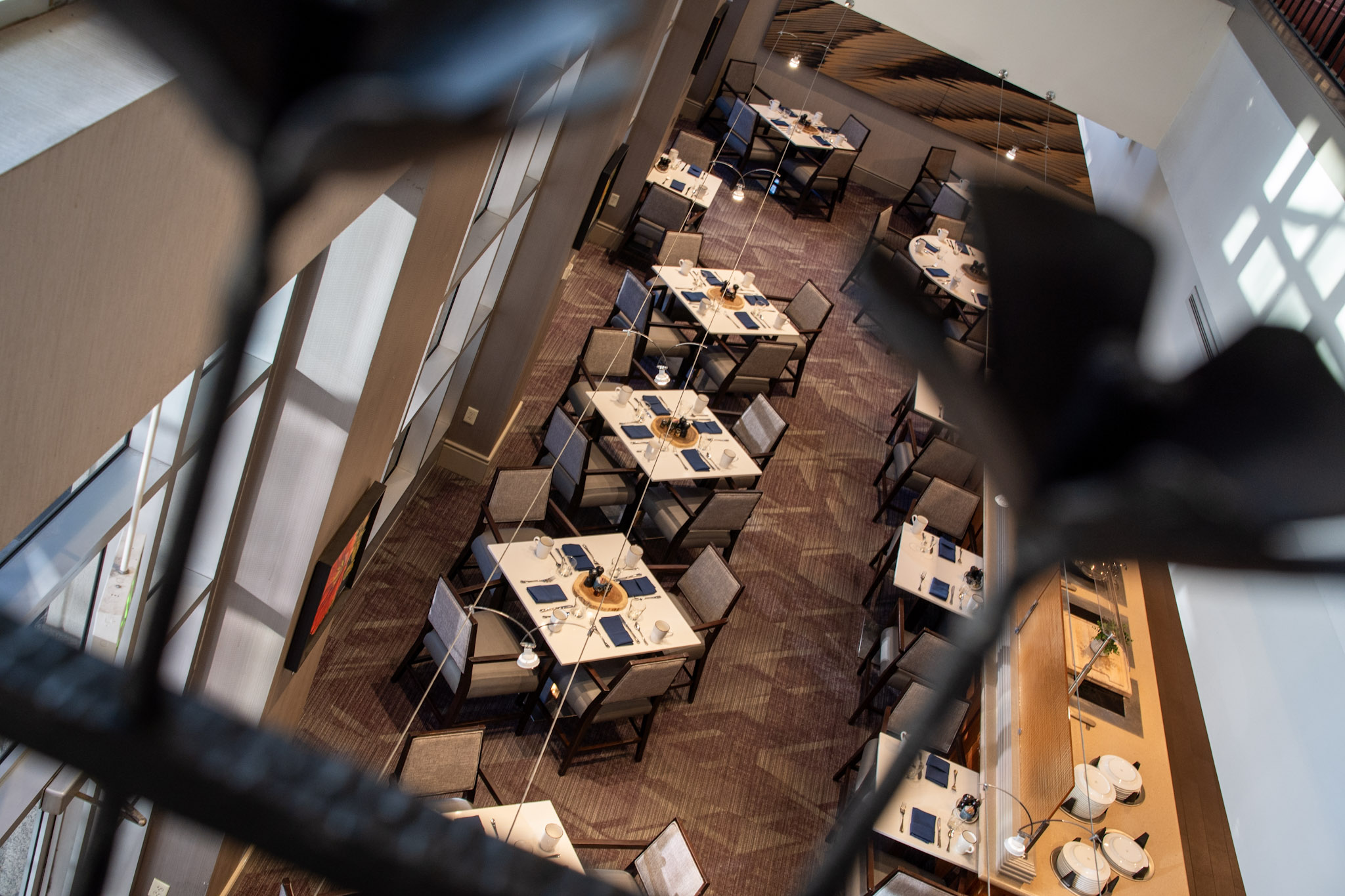a view from the top of a room with tables and chairs