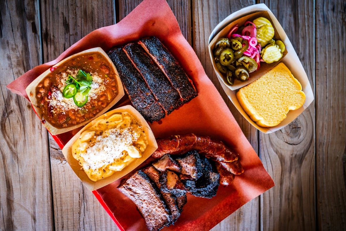 a plate of food sitting on top of a wooden table