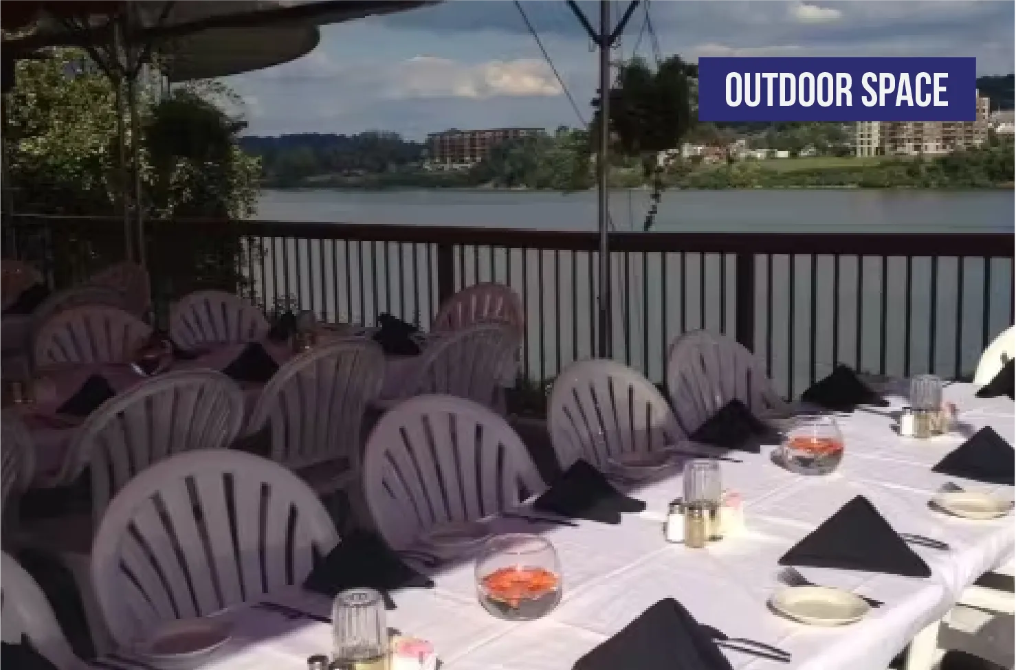 Riverside outdoor patio dining with waterfront view seating