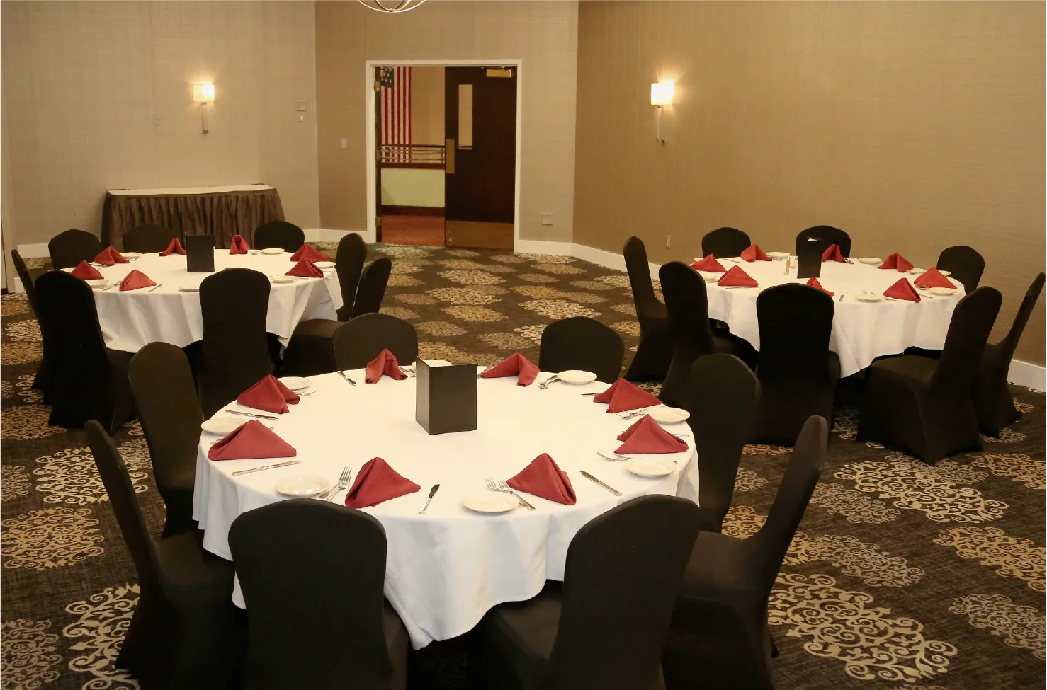 Banquet Room A private event space with round tables and black chair covers
