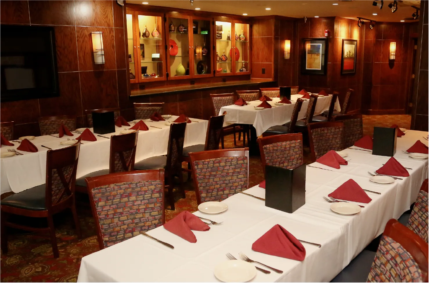 The Back Room private dining space with wood paneling and glass display cabinet
