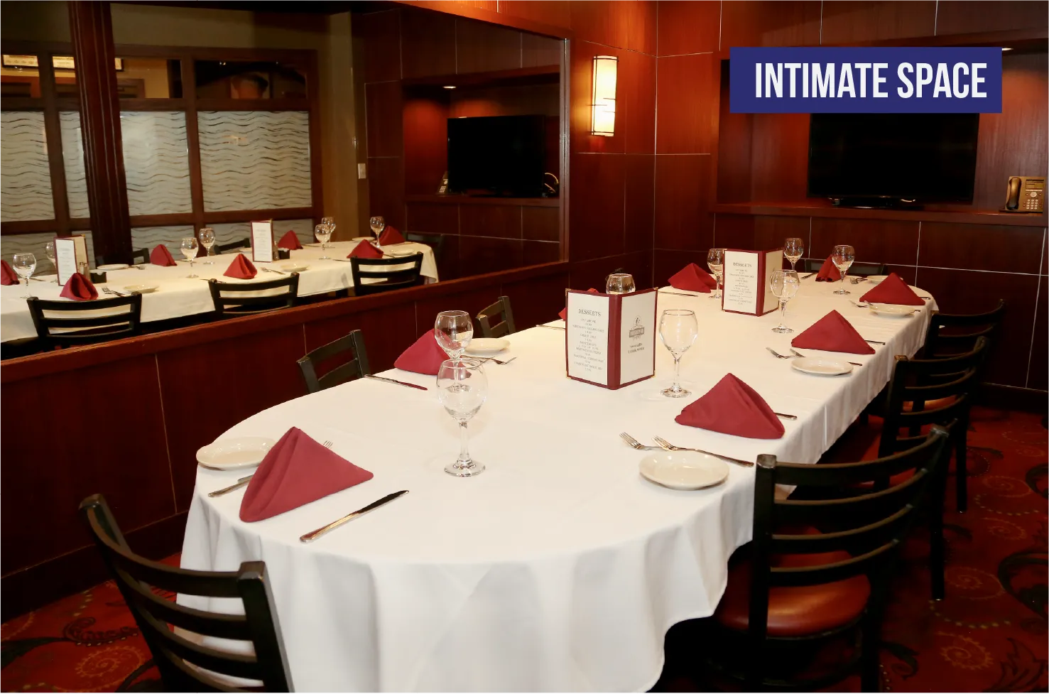 The King Room intimate private dining space with wood-paneled walls and TVs