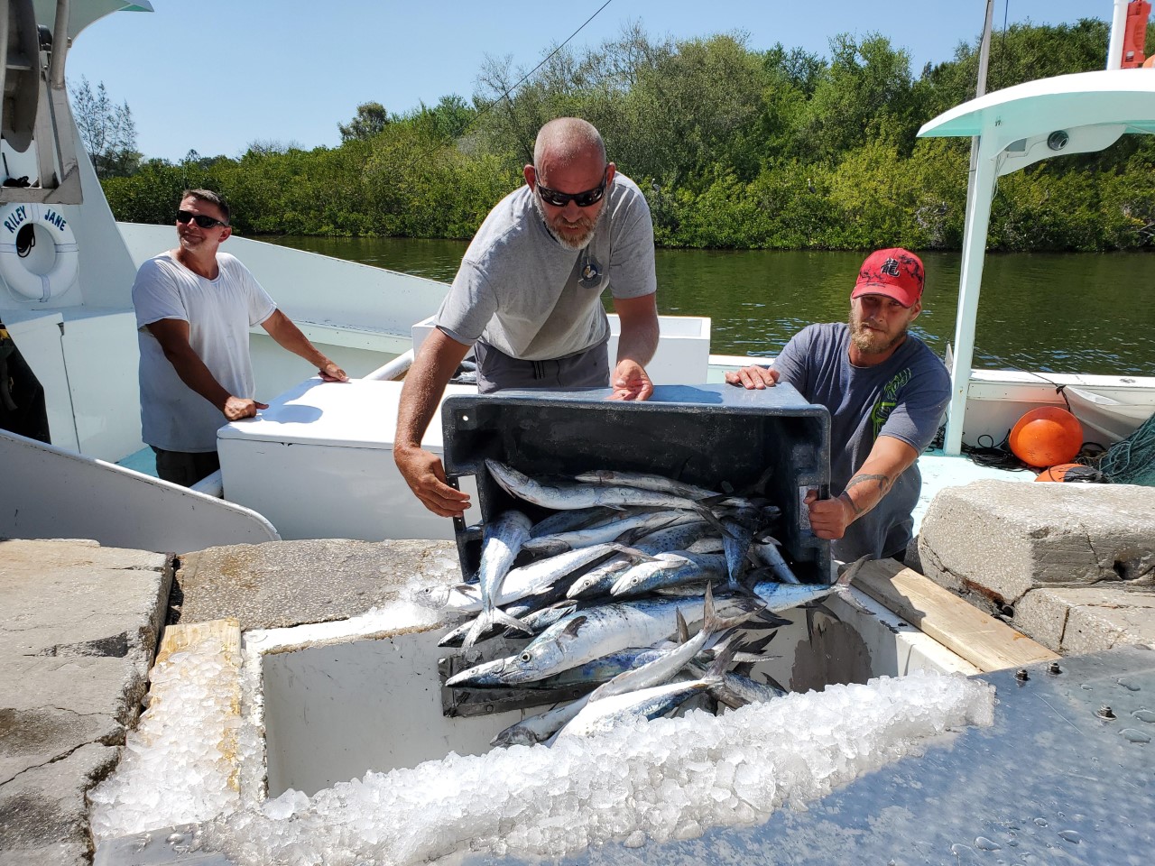 a group of people sitting in the snow