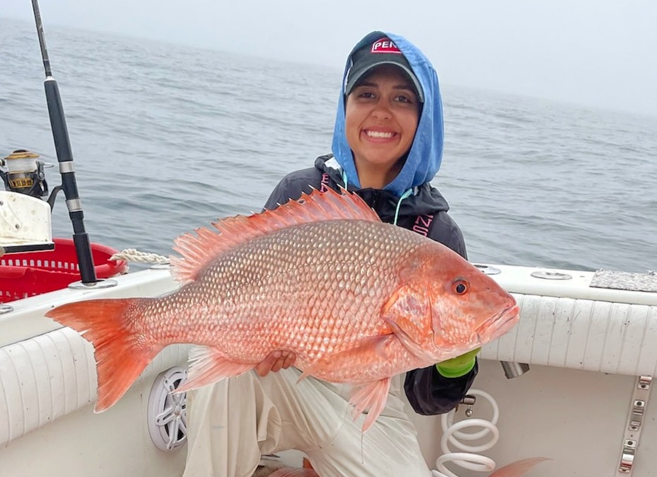 a person holding a fish on a boat in the water