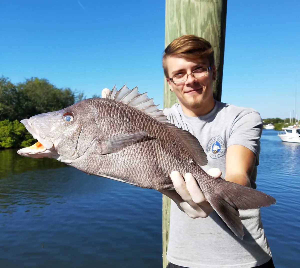 a man holding a fish in the water