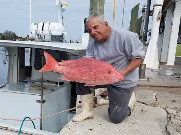 a man holding a big fish
