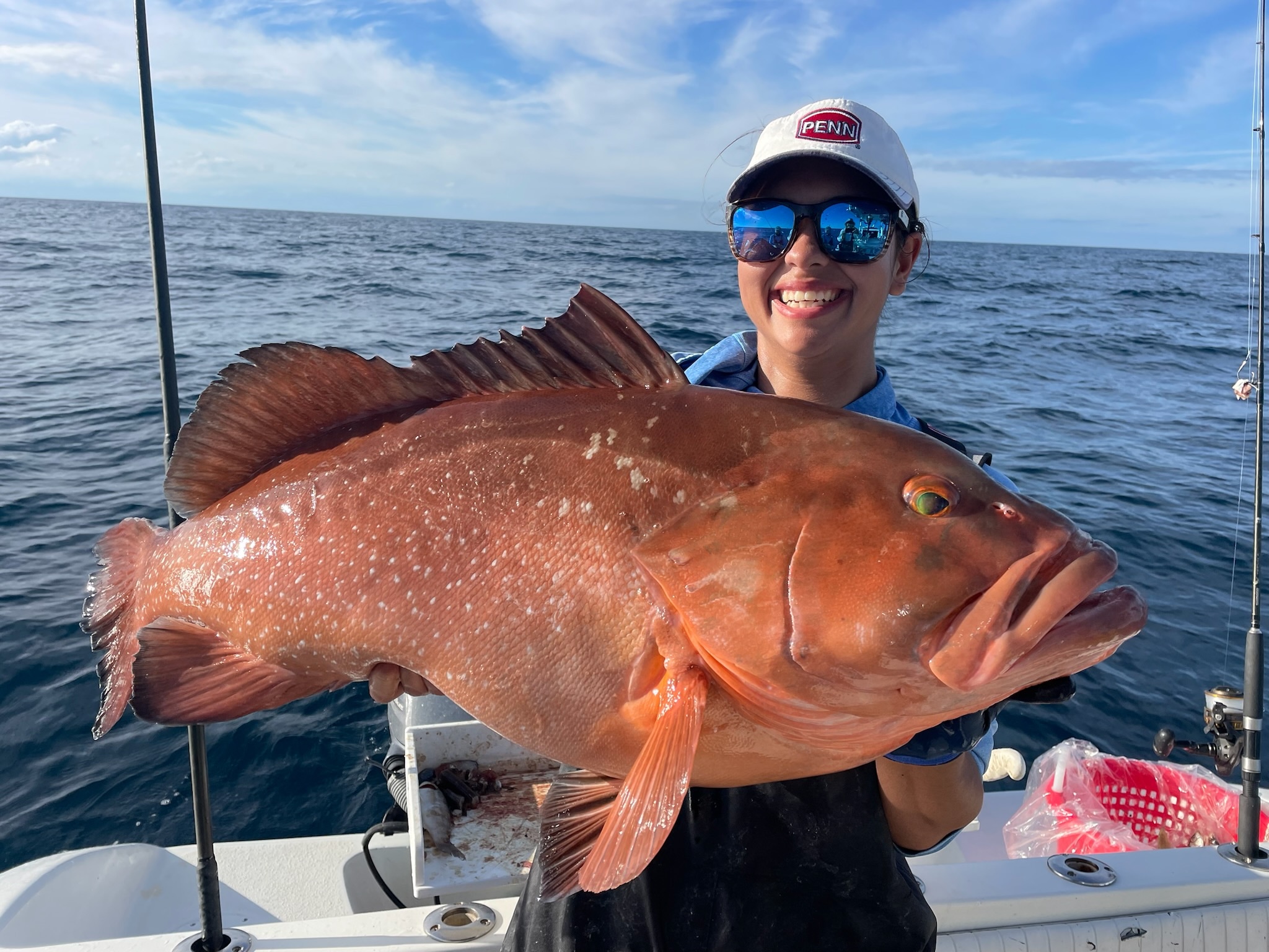 a person holding a fish on a boat in a body of water