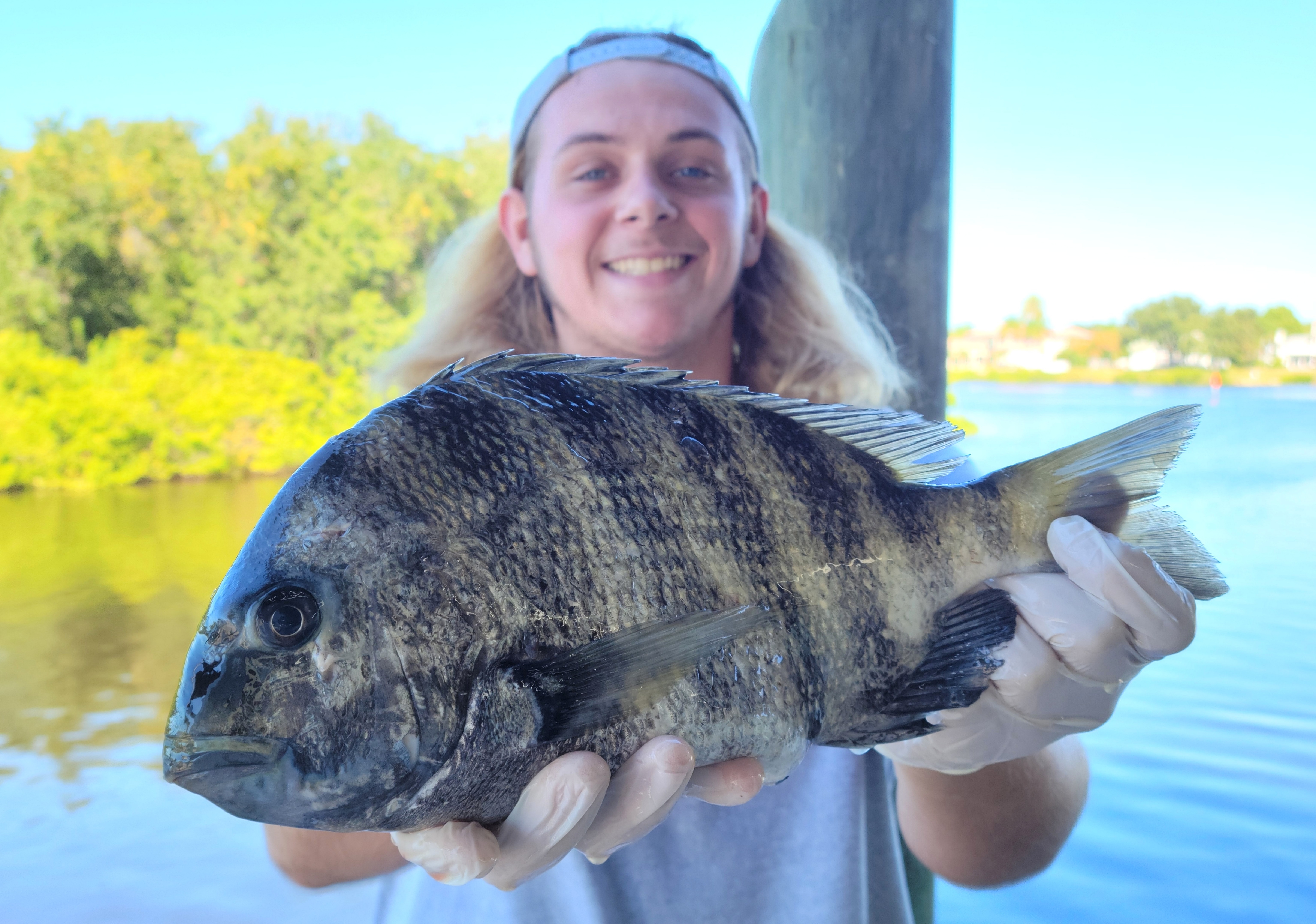 a person holding a fish in the water