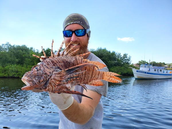 a man holding a big lobster