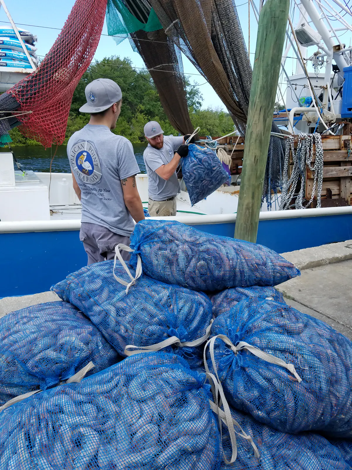 a man carrying a pile of seafood